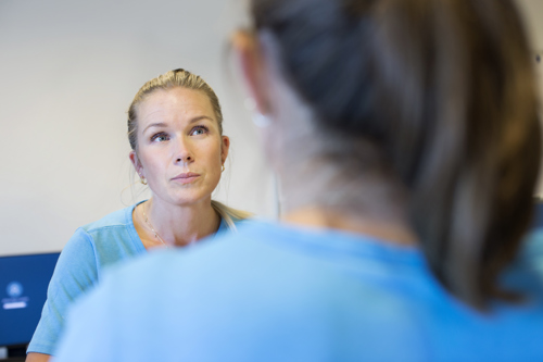 To sygeplejersker i samtale med hinanden.